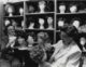 Two older women with lots of mannequin heads.