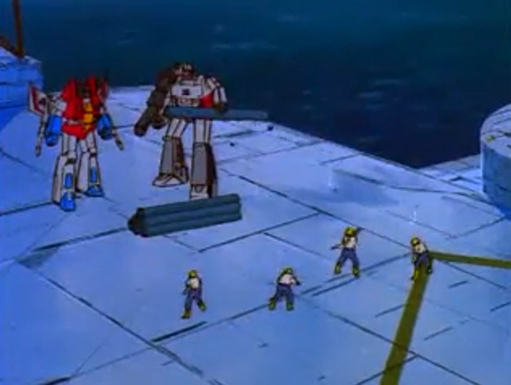 Humans throwing wrenches at Decepticons.