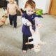 Baby girl puts her doll upside down