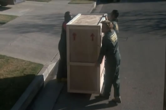 The team moves a piano crate