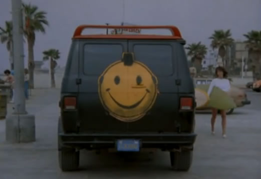 The van has a smiley face on its back doors!
