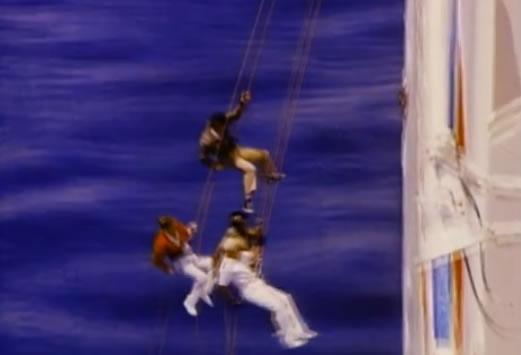 The team rappels off the side of the ship