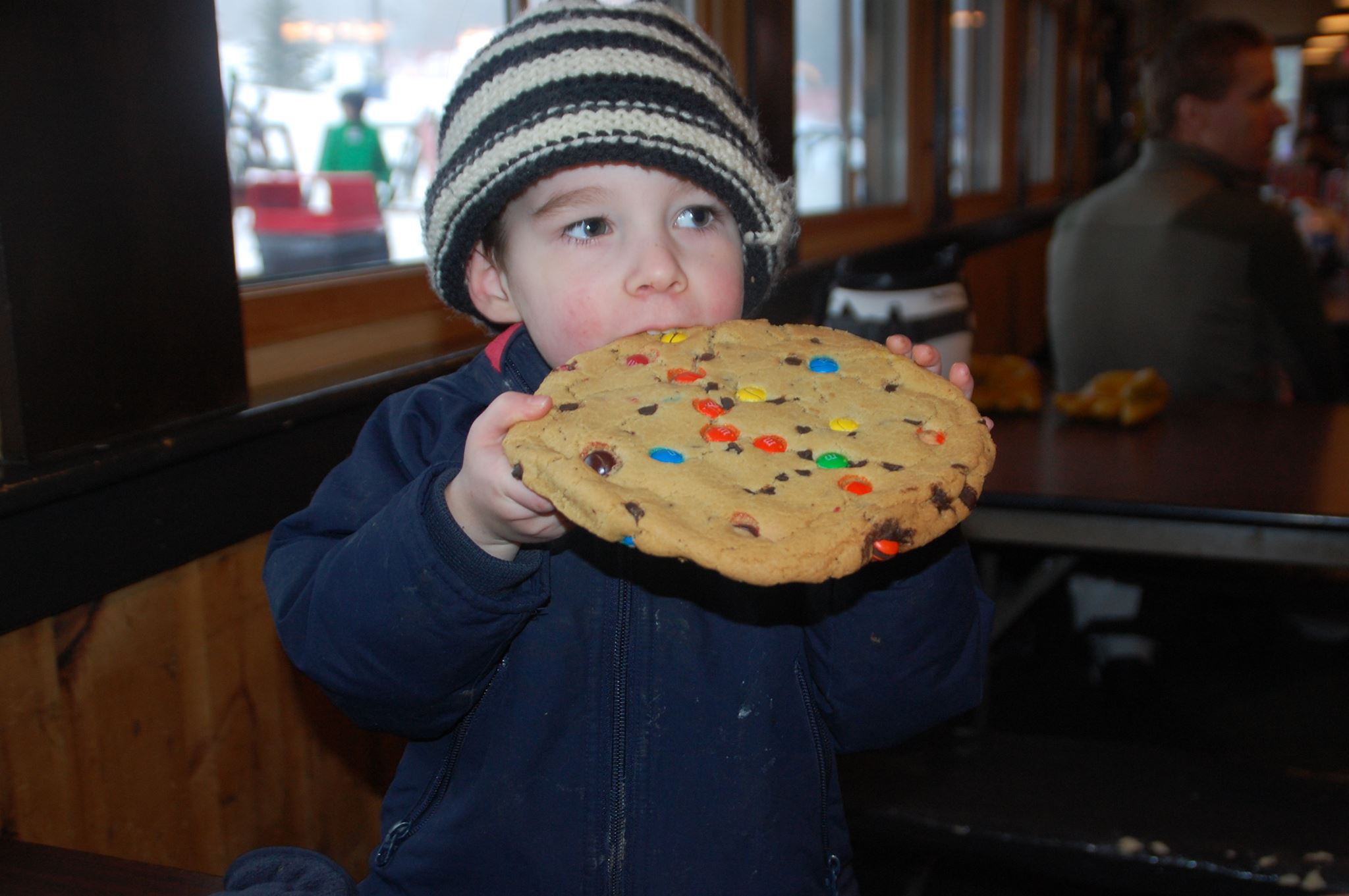 Three year old eats an M&M cookie that's bigger than his head