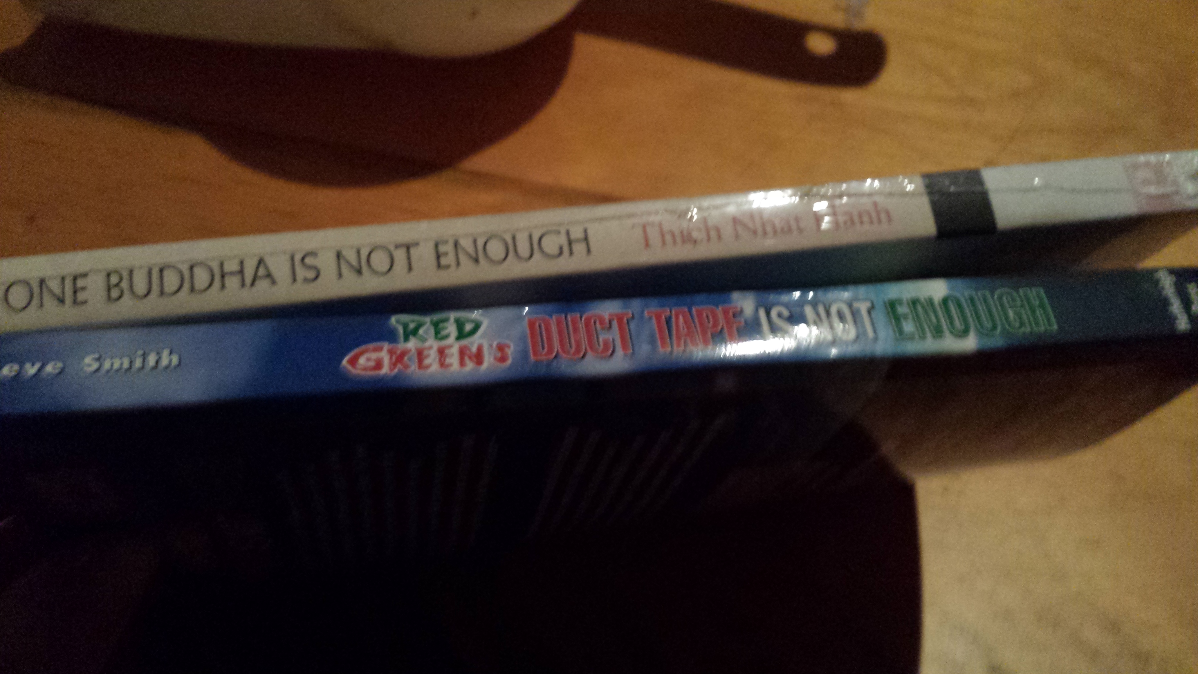 Two books: "One Buddha is Not Enough" and "Duct Tape is Not Enough"