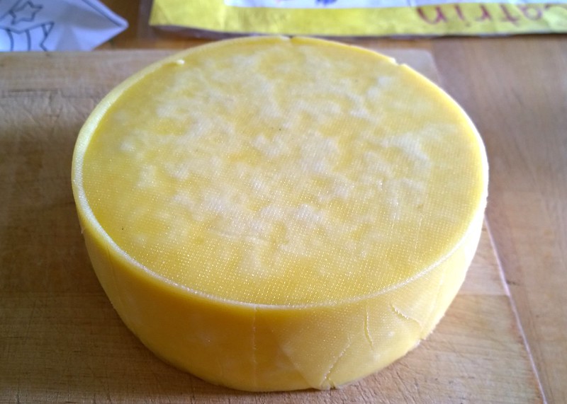A newly waxed wheel of homemade cheddar cheese. (Photo by Ruth Hartnup via Flickr/Creative Commons https://flic.kr/p/xrEpZT)