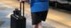 A woman uses the smart suitcase in an airport while also using a cane. (Screenshot from video by Carnegie Mellon University https://www.cmu.edu/news/stories/archives/2019/may/suitcase-helps-navigate-airports.html)