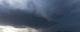 A wide photo of the massive clouds in a "super cell," with a group of cows looking at the camera in the foreground. (Photo by Daniel Rodriguez via Flickr/Creative Commons https://flic.kr/p/nk8YiR)