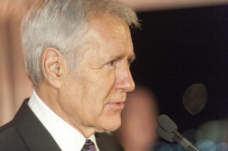 Television personality Alex Trebek delivers remarks at the USO 75TH Anniversary Reception in Washington D.C. Feb. 4th, 2016. U.S. Marine Gen. Joseph F. Dunford Jr., chairman of the Joint Chiefs of Staff, served as the event's keynote speaker. (DoD Photo by Navy Petty Officer 2nd Class Dominique A. Pineiro) Chairman of the Joint Chiefs of Staff - Flickr/Creative Commons https://flic.kr/p/DRmKDi