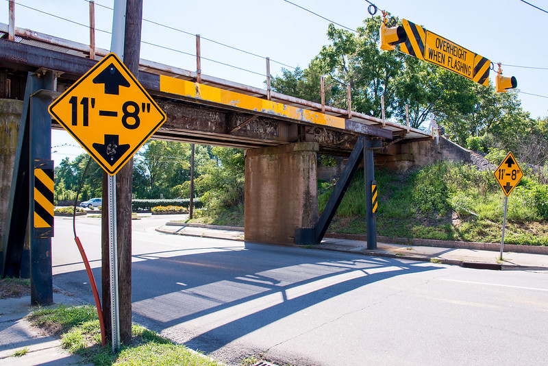 The bridge with a "warning 11'8"' sign next to it. (Photo by Mark Clifton via Flickr/Creative Commons https://flic.kr/p/wZ8eFm)