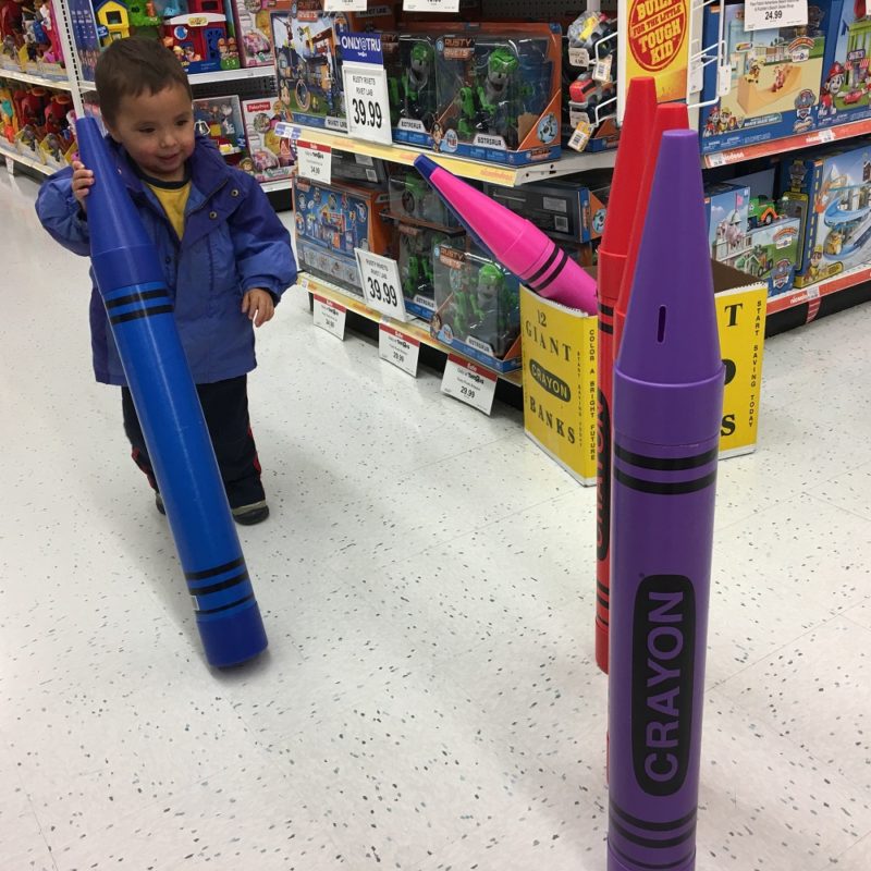 Two year old with giant crayons