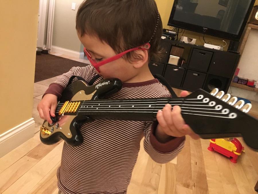 Two year old rocks out with a guitar
