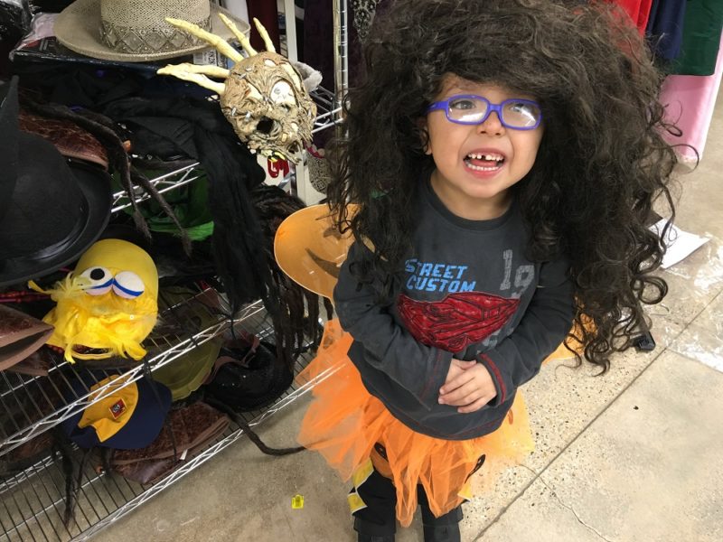 Four year old as a "pumpkin fairy" with a giant wig
