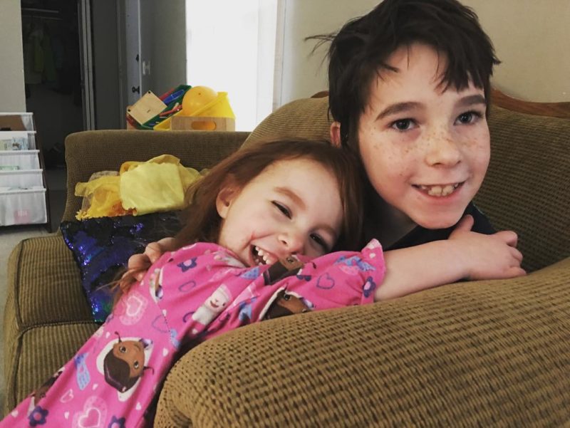 Three year old gets hugs from her bro