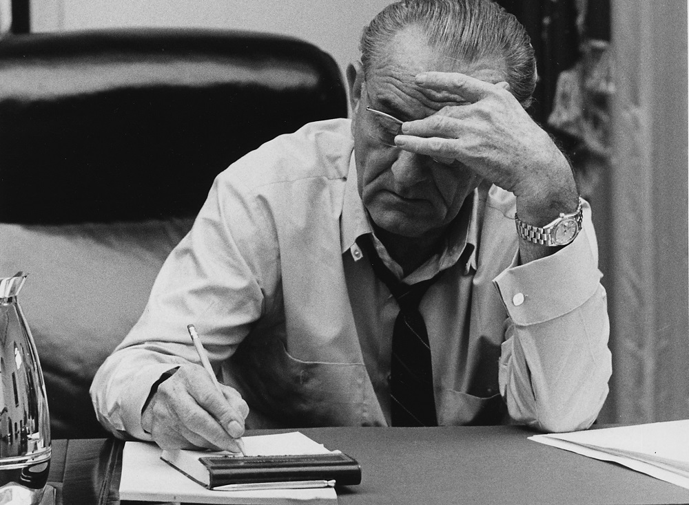 Lyndon Johnson takes notes while in the White House Cabinet Room. (National Archives and Records Administration via Wikicommons https://commons.wikimedia.org/wiki/File:Moods,_President_Lyndon_B._Johnson_making_notes_in_a_Cabinet_Room_meeting_-_NARA_-_192615.tif)