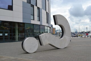 A big question mark turned on its side outside a building in Ipswich. (Photo by Benjamin Reay via Flickr/Creative Commons https://flic.kr/p/oqa96H)