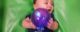 Baby boy is excited about the glowing toy ball