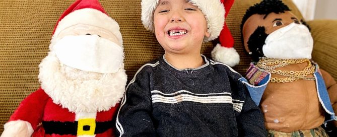 Five year old with Santa and Mr. T (who are wearing masks)