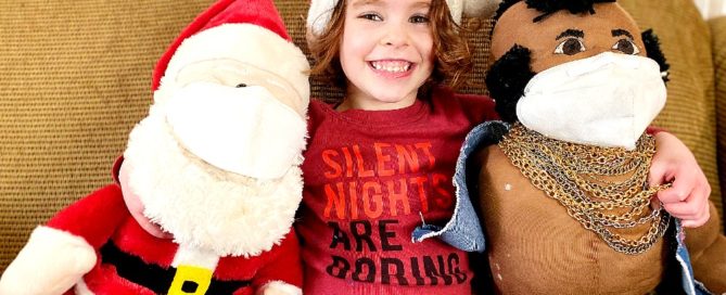 Four year old with Santa and Mr. T (who are wearing masks)