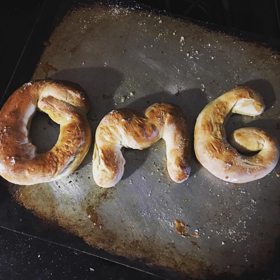 Three homemade baked pretzels spell out OMG