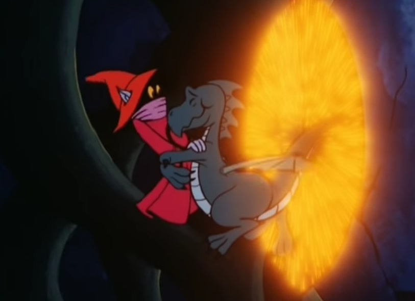 A baby dragon hugs a nervous Orko