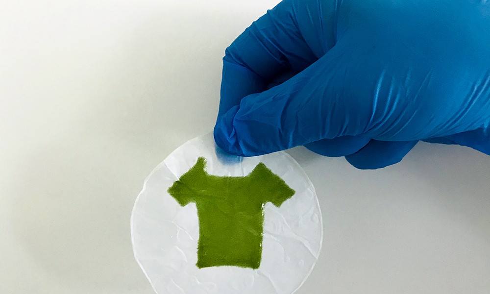 A green mini T-shirt made of photosynthetic living materials. (University of Rochester photo)