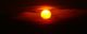 A bright orange sun with some clouds moving through. (Photo by Maclej via Flickr/Creative Commons https://flic.kr/p/Cyw2E)