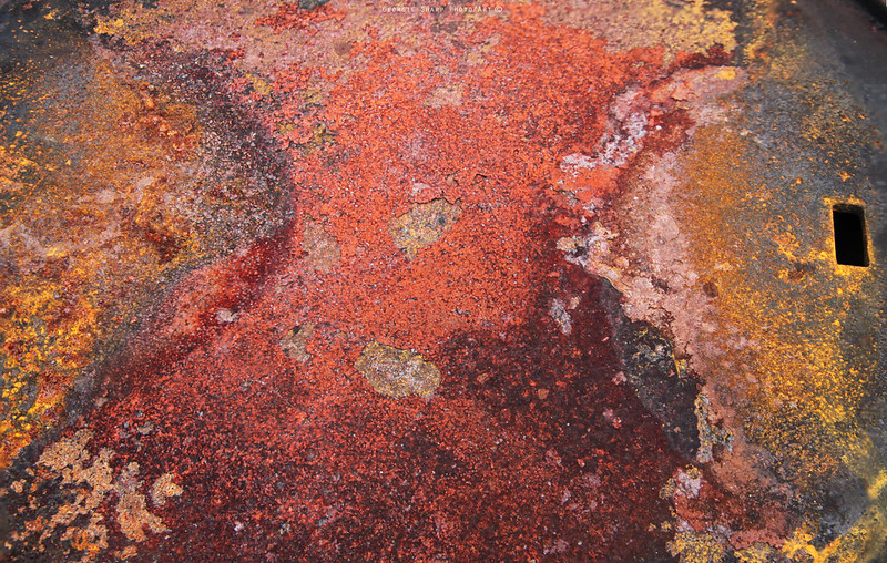 Rusted metal with patches of red, grey, yellow and orange. (Photo by Georgie Sharp via Flickr/Creative Commons https://flic.kr/p/LKwm76)