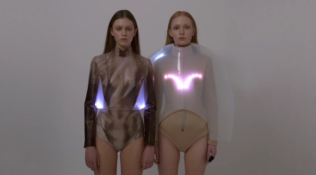 Screenshot from Emotional Clothing Collection video. It shows two women wearing clothes that have lights embedded in them.