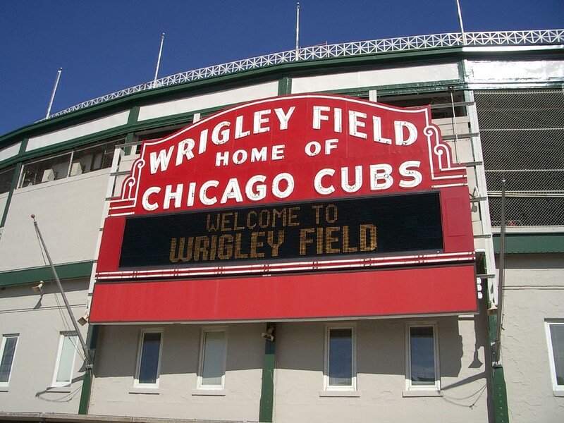 The big red sign that says "Wrigley Field - Home of Chicago Cubs" (Photo by Jordan via Flickr/Creative Commons https://flic.kr/p/ndg47)