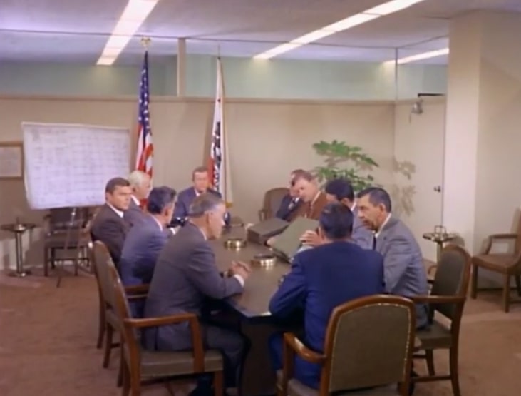 Secret Service agents and LAPD personnel at a conference table