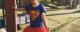 Two year old is happy because she's dressed up as Supergirl.