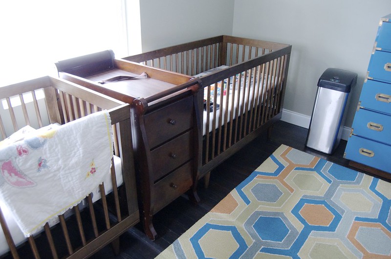 Two baby cribs and a changing table (Photo by Emily May via Flickr/Creative Commons https://flic.kr/p/rcoSKB)