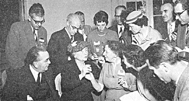 Helen Keller, surrounded by journalists, communicates with her helper Polly Thomson. On the left is Conrad Bonnevie-Svendsen, the Norwegian Chairman of the Rotary International Convention Committee. (Photo by Wikicommons https://commons.wikimedia.org/wiki/Category:Helen_Keller_in_1950#/media/File:Keller,_Thomson,_Bonnevie-Svendsen.jpg)