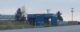 A blue, two lane car wash building with the word BAYWASH written in flashy, Baywatch-style lettering.