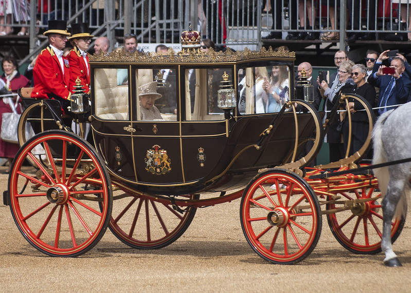 Queen Elizabeth rides in a horse-drawn carriage during the Trooping the Colour parade, June 8, 2019. (DOD photo by U.S. Navy Petty Officer 1st Class Dominique A. Piniero, via Flickr/Creative Commons https://flic.kr/p/2gaNZYc)