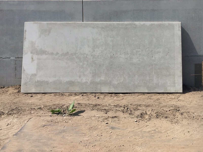 A rectangular concrete slab leaning against a concrete wall. (Photo via Joost Markerink via Flickr/Creative Commons https://flic.kr/p/252wpNx)