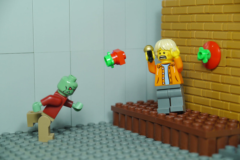 A Lego zombie throws Lego tomatoes at a scared Lego standup comedian. (Photo by BRICK 101 via Flickr/Creative Commons https://flic.kr/p/FRwXac)