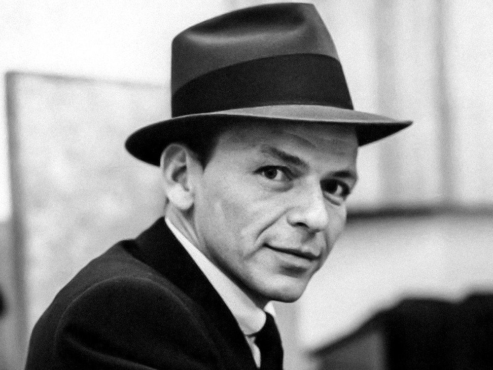 Frank Sinatra in Capitol Studios, circa October 1957, during the recording of Come Fly with Me. Via Wikicommons https://commons.wikimedia.org/wiki/Category:Frank_Sinatra#/media/File:Frank_Sinatra_(1957_studio_portrait_close-up).jpg