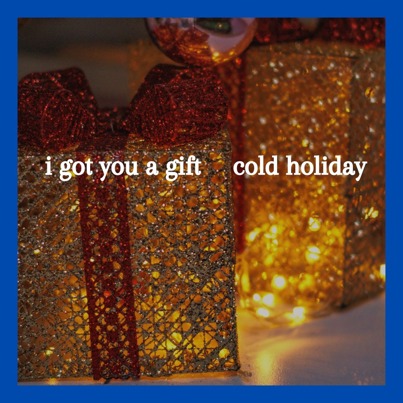 The cover of "I Got You A Gift" by Cold Holiday shows two glittery gold presents with red ribbon, illuminated by white lights. Photo by Daniel Kondrashin via Pexels https://www.pexels.com/photo/christmas-ball-beside-glittery-gift-boxes-in-close-up-view-14543809/