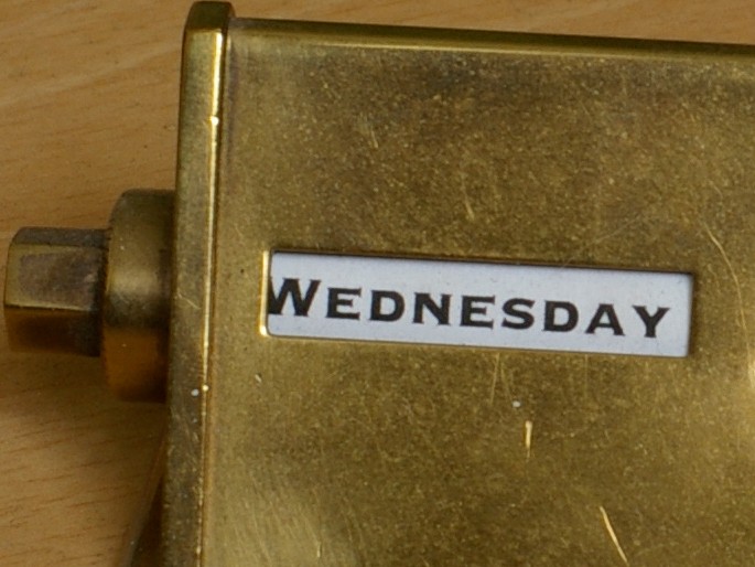 Close up on the word "Wednesday" in a gold and white perpetual calendar. (Photo by plenty.r via Flickr/Creative Commons https://flic.kr/p/67CYEw)