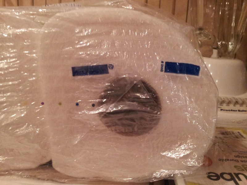 A roll of paper towels on its side. The roll coupled with two black horizontal lines on the plastic packaging look like the roll is making an exasperated face. (Photo by Charity Davenport via Flickr/Creative Commons https://flic.kr/p/G9VhC3)