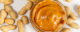 Glass jar of peanut butter with peanuts on white background, top view. (Photo by Marco Verch, Professional Photographer, via Flickr/Creative Commons https://flic.kr/p/2j6GACA)