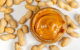 Glass jar of peanut butter with peanuts on white background, top view. (Photo by Marco Verch, Professional Photographer, via Flickr/Creative Commons https://flic.kr/p/2j6GACA)