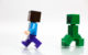 A Lego Minecraft Steve minifigure walks away from a Lego Minecraft Creeper figure. (Photo by Lego Photo mureut via Flickr/Creative Commons https://flic.kr/p/quYHMf)