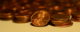 Small stacks of pennies, with one turned on its side to show the Abraham Lincoln portrait. (Photo by slgckgc via Flickr/Creative Commons https://flic.kr/p/azwPMu)