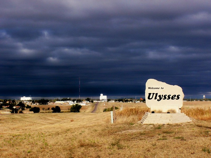 A welcome sign that reads "Welcome to Ulysses," with a dramatic cloudy sky in the background. (Photo by J. Stephen Conn via Flickr/Creative Commons https://flic.kr/p/5bfQeJ)