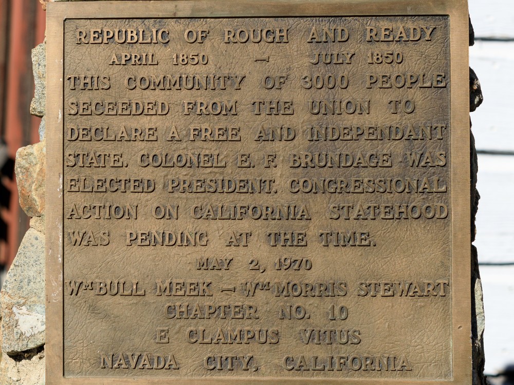 A historic marker reads: "Republic of Rough and Ready April 1850-July 1850. This community of 3000 people seceded from the Union to declare a free and independant (sic) state. Colonel E.F. Brundage was elected president. Congressional action on California statehood was pending at the time. May 2, 1970. Wm Bull Meek - -Wm Morris Stewart Chapter No. 10 E. Clampus Vitus Navada City, California. Photo by Frank Schulenburg - Own work, CC BY-SA 4.0, via Wikicommons https://commons.wikimedia.org/w/index.php?curid=95241019