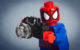 A Lego minifig of Spider-Man taking a photo with a Lego camera. (Photo by : : w i n t e r t w i n e d : : via Flickr/Creative Commons https://flic.kr/p/kHnLNS)