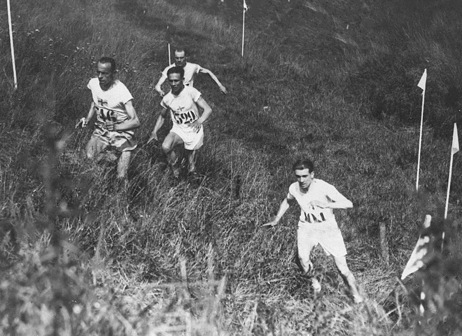 Edvin Wide (left, #746) leads Ville Ritola and Paavo Nurmi during the Individual Cross Country event at the 1924 Olympic Games in Paris. Nurmi won the gold and Ritola the silver medal. Photo via Wikicommons https://en.wikipedia.org/wiki/Athletics_at_the_1924_Summer_Olympics_–_Men%27s_individual_cross_country#/media/File:Ind_cross_country_1924_Summer_Olympics.jpg