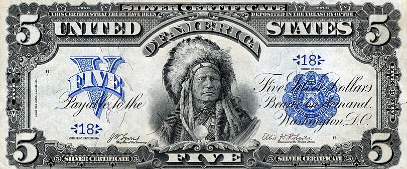 A $5 silver certificate featuring the likeness of Tȟatȟóka Íŋyaŋke, a Hunkpapa Lakota chief also known as Running Antelope. (Image from the National Numismatic Collection at the Smithsonian Institution, via Wikicommons https://en.wikipedia.org/wiki/Running_Antelope#/media/File:US-$5-SC-1899-Fr.271.jpg) 